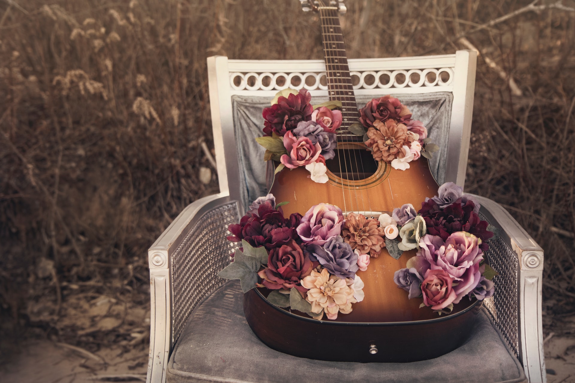 A guitar with wedding decoration on it